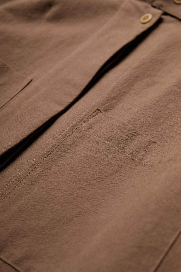 The Tenet Blouson Shirt is crafted from a textural cotton fabric in Brown and has a centre concealed button placket.