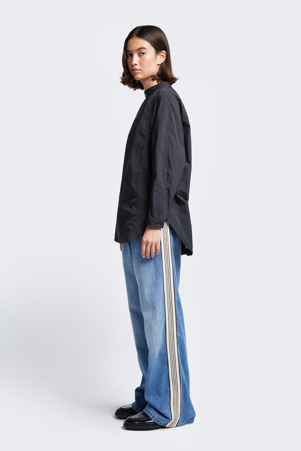 Side profile of the Tribute Side Trim Pant with stripe trim detail. Made from softened cotton in a signature blue wash fade treatment. Features side and rear pockets. 