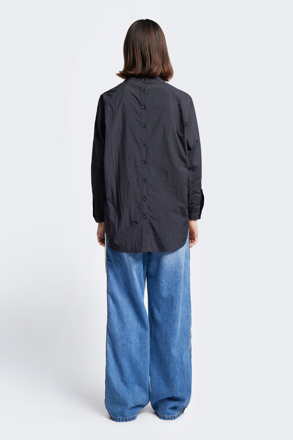 The back of the Tribute Side Trim Pant, a wide leg pant made from softened cotton in a signature blue wash fade treatment. Features side and rear pockets. 