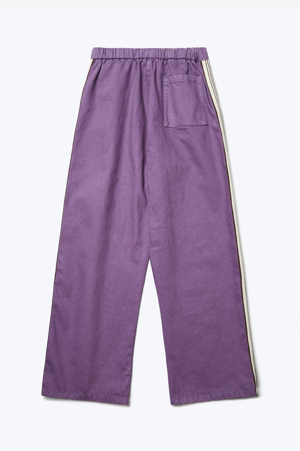 Flat lay of the back of the Tribute Side Trim Pant Purple, a wide leg pant made from softened cotton. Finished with an elasticated waist and rear patch pocket.