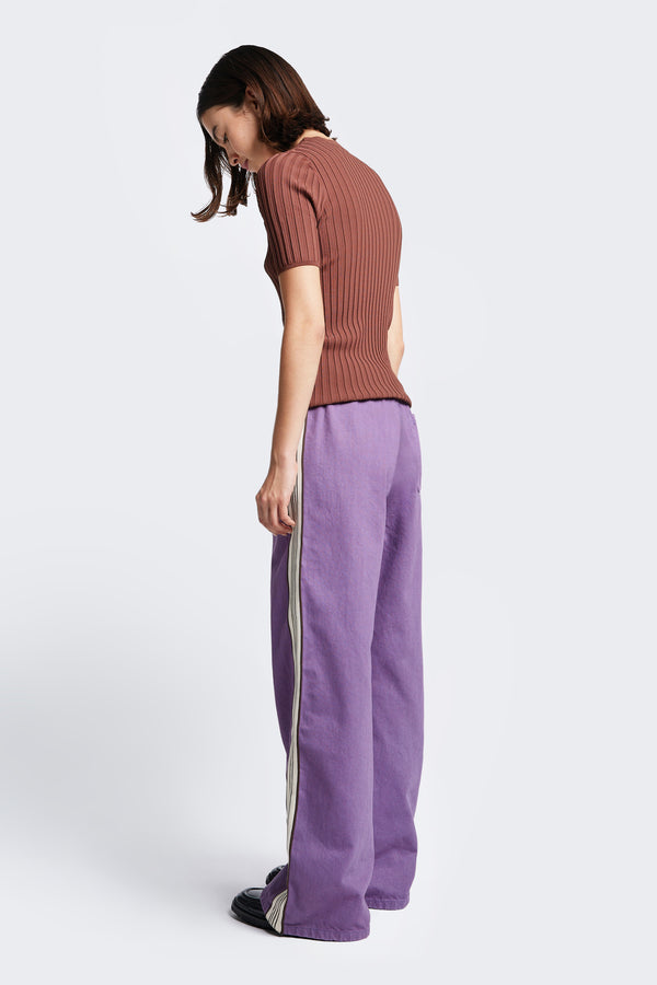 The back of the Tribute Side Trim Pant, a wide leg pant made from softened cotton Purple. Features side and rear pockets. The laidback fit feel as good on as your oldest trackies.