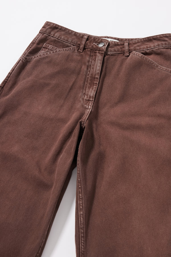 Close-up of the oversized coin pocket and front pocket detailing on the brown fade Unbound Jean.