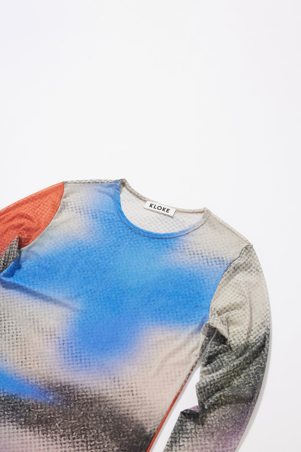 Close-up detail shot of the Kloke-designed Aion Print on the vapour top in a lightweight semi-sheer stretch mesh.