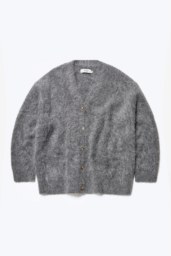 Flat lay of the Vessel V Neck Cardigan Charcoal, made from a special Alpaca blend this knit is soft, fuzzy and warm.  Finished with button closure, dropped shoulder and two welt pockets at the front.