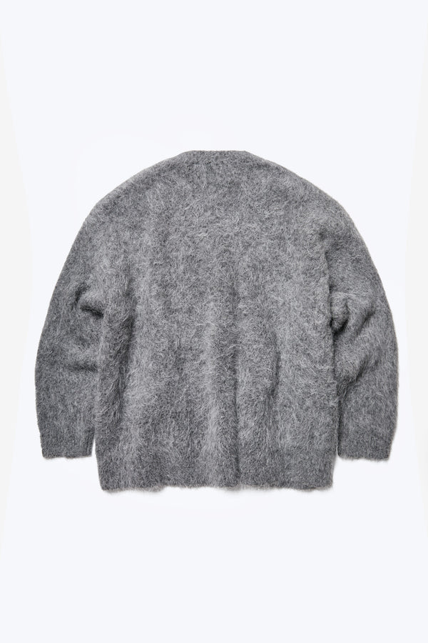 The back of the Vessel V Neck Cardigan, a loose and fuzzy cardigan made from a special Alpaca blend in Charcoal Grey. This knit is made to be worn big.