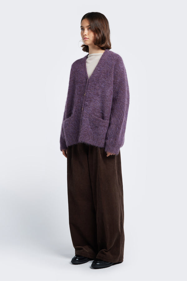 The Vessel V Neck Cardigan Purple is a loose and fuzzy knit made from a special Alpaca blend.  Finished with button closure, dropped shoulder and two welt pockets at the front.