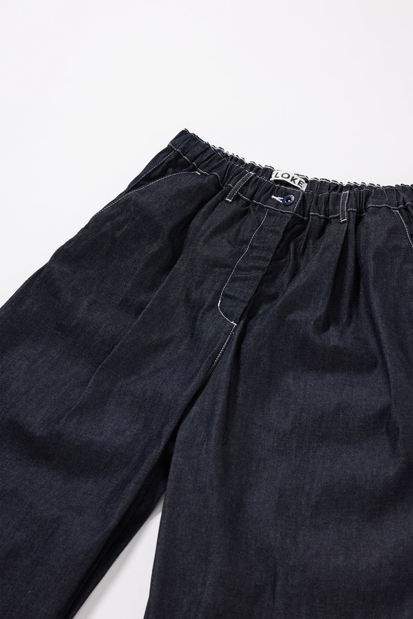 Close up detail shot of the dark indigo Wisp elasticated jean, highlighting the contrast stitching and raw colour