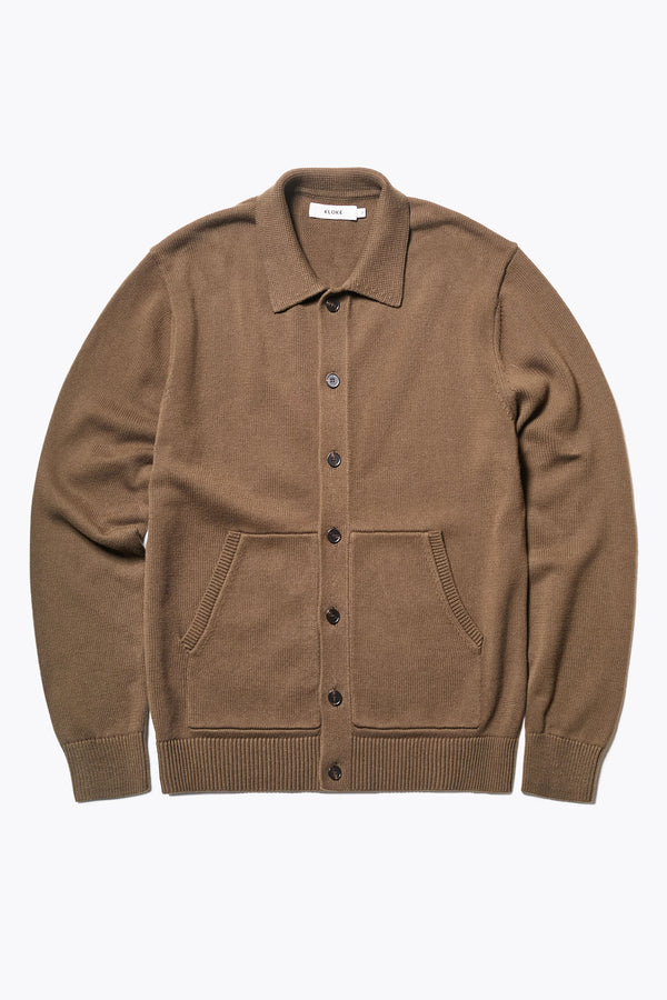 The Anvil Collar Cardigan in Brown Olive, a heavier cotton knit styled as a jacket or cardigan, featuring a built-in collar, practical front pockets. Available in 5 sizes. 