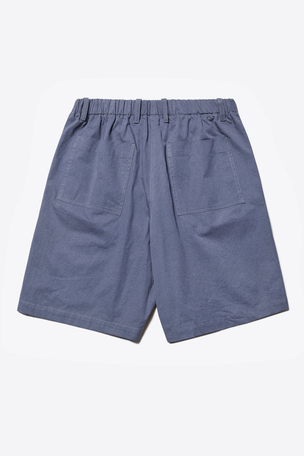 Back of The Degree Pleat Short, a laidback and adaptable easy to weather summer short. Crafted in a blue washed cotton herringbone twill. Available in 5 sizes. 