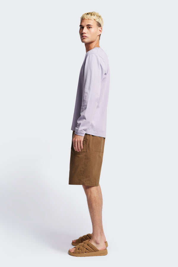 Side of the Degree Pleat Short, a laidback and adaptable easy to weather summer short. Crafted in a brown washed cotton herringbone twill. Available in 5 sizes. 