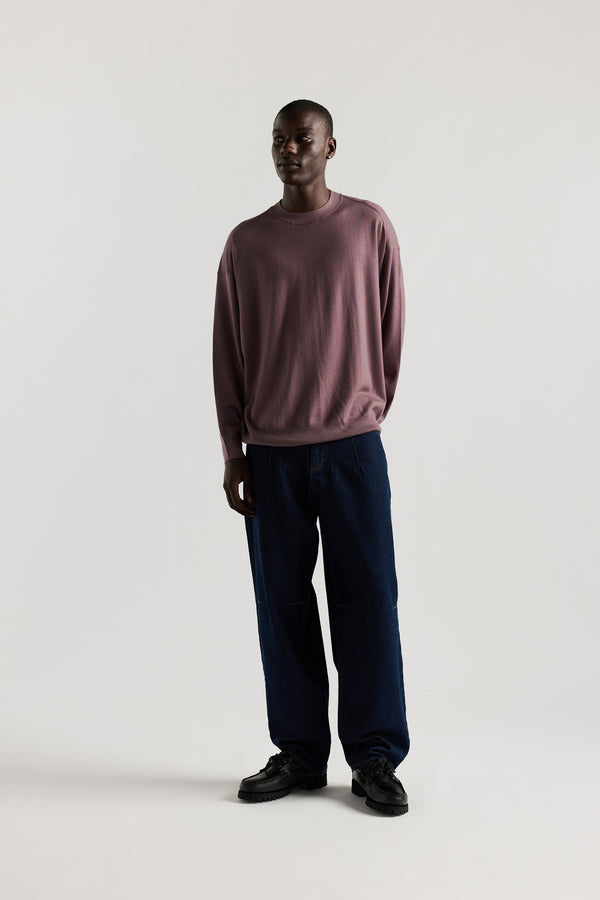 Male model wearing oversized Japanese denim jeans with a relaxed baggy fit, darted waist and knee detailing, and classic five-pocket styling