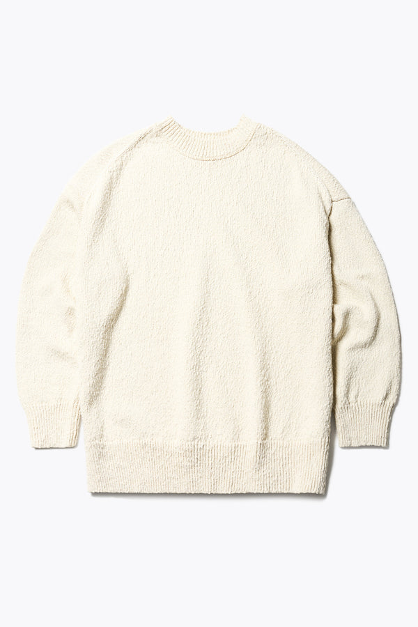 Flat Front of the ecru Hill Slub Sweater in textured cotton slub knit with an oversized fit, raglan sleeves, and ribbed trim at the hem and cuffs.