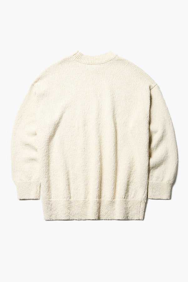 Flat back of the ecru Hill Slub Sweater in textured cotton slub knit with an oversized fit, raglan sleeves, and ribbed trim at the hem and cuffs.
