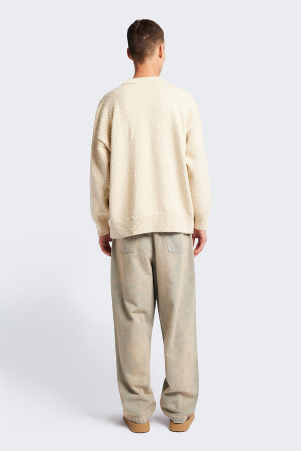 Back of the ecru Hill Slub Sweater in textured cotton slub knit with an oversized fit, raglan sleeves, and ribbed trim at the hem and cuffs.