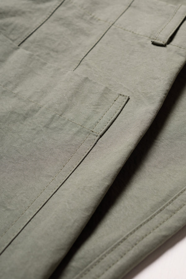 Close up shot of the fabric and pocket detailing on the Olive Lenz Pant with straight-leg silhouette, front patch pockets and twin-needle topstitch detail.