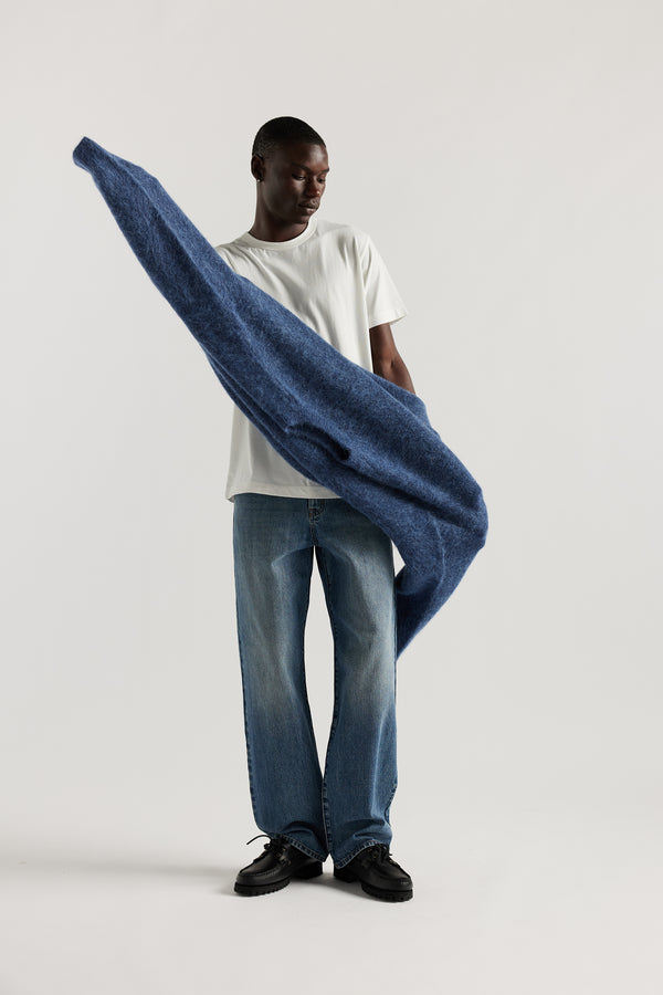 Front of Model wearing oversized fluffy alpaca  knit crew neck sweater in indigo blue. 
