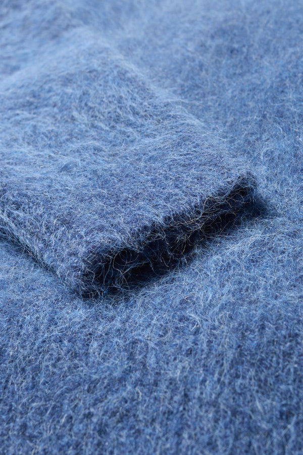 Close up fabric detail of the Marlin, oversized fluffy knit crew neck sweater in indigo blue. 
