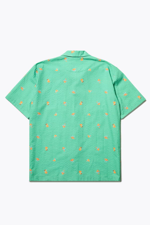 Flat Back of the Mirari in Green floral, a relaxed short-sleeve open-collar camp shirt made from soft textured cotton seersucker, offering a laid-back fit. Available in 5 sizes. 
