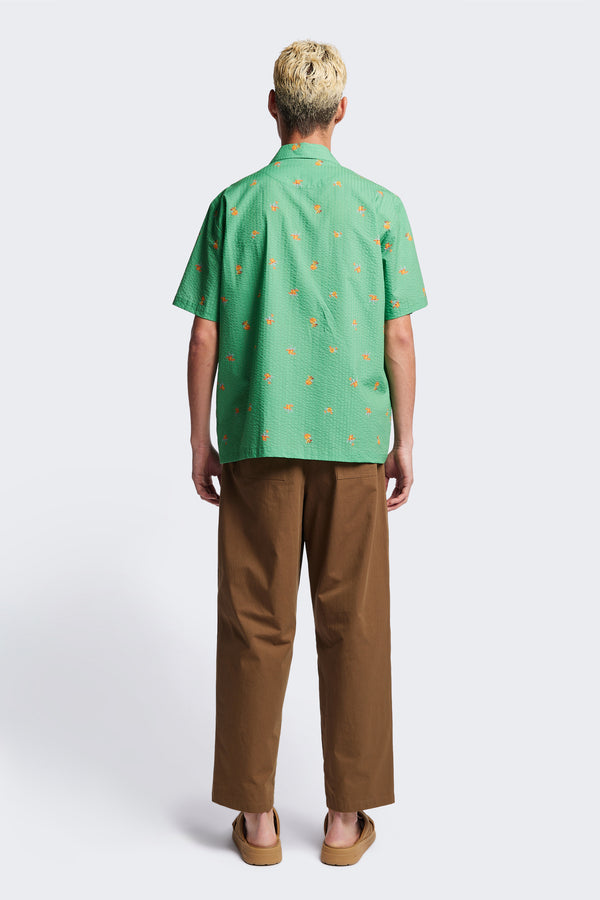 Back of the Mirari in Green floral, a relaxed short-sleeve open-collar camp shirt made from soft textured cotton seersucker, offering a laid-back fit. Available in 5 sizes. 
