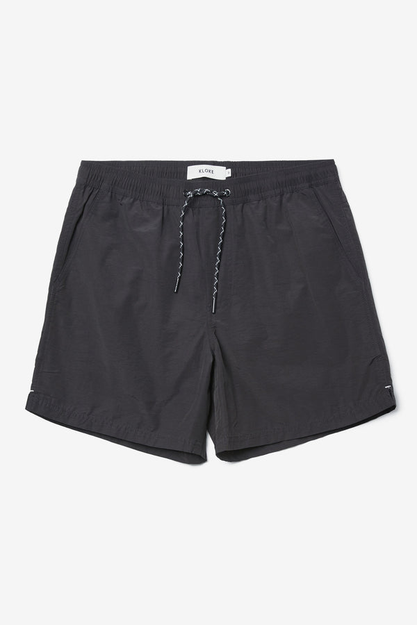 The New Wave Short in Black. Swim shorts with elastic drawstring waist, internal mesh support, and front slant pockets. Available in 5 sizes.