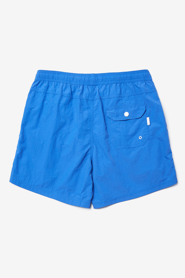 Back of The New Wave Short in Lapis Blue. Swim shorts with elastic drawstring waist, internal mesh support, and front slant pockets. Available in 5 sizes.