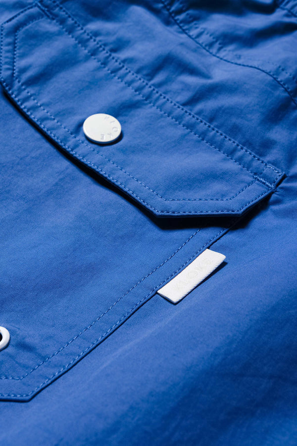 Close up details of The New Wave Short in Lapis Blue. Swim shorts with elastic drawstring waist, internal mesh support, and front slant pockets. Available in 5 sizes.