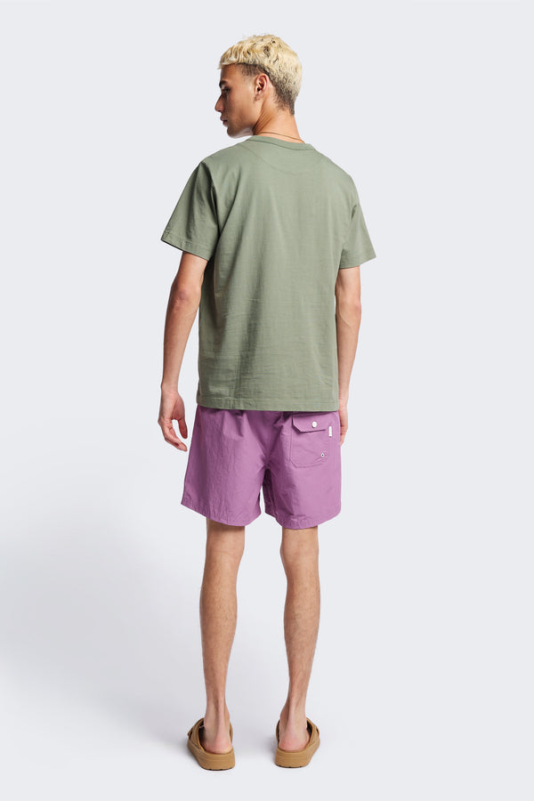 Back of The New Wave Short in Purple Fade. With Utilitarian features like an elastic drawstring waist, internal mesh support, front slant pockets, and back patch pocket. Available in 5 sizes.