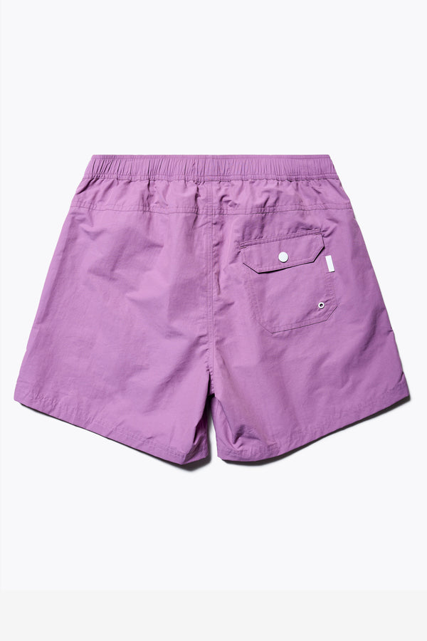 Back of The New Wave Short in Purple Fade. With Utilitarian features like an elastic drawstring waist, internal mesh support, front slant pockets, and back patch pocket. Available in 5 sizes.