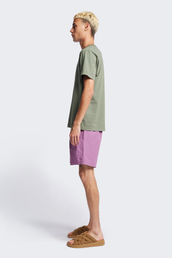 Side of The New Wave Short in Purple Fade. With Utilitarian features like an elastic drawstring waist, internal mesh support, front slant pockets, and back patch pocket. Available in 5 sizes.