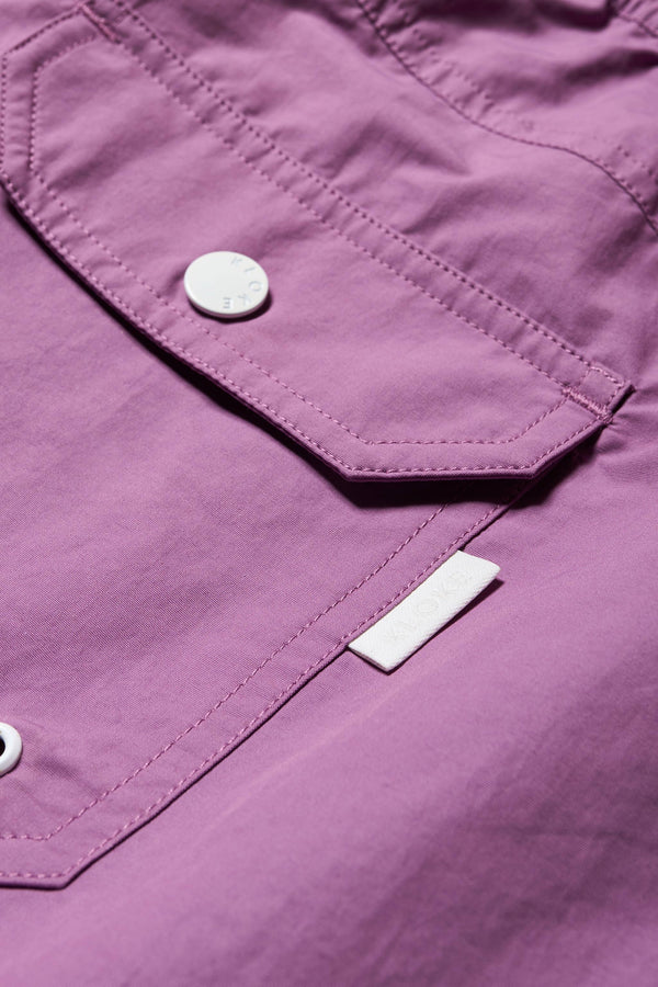 Close up details of The New Wave Short in Purple Fade. With Utilitarian features like an elastic drawstring waist, internal mesh support, front slant pockets, and back patch pocket. Available in 5 sizes.