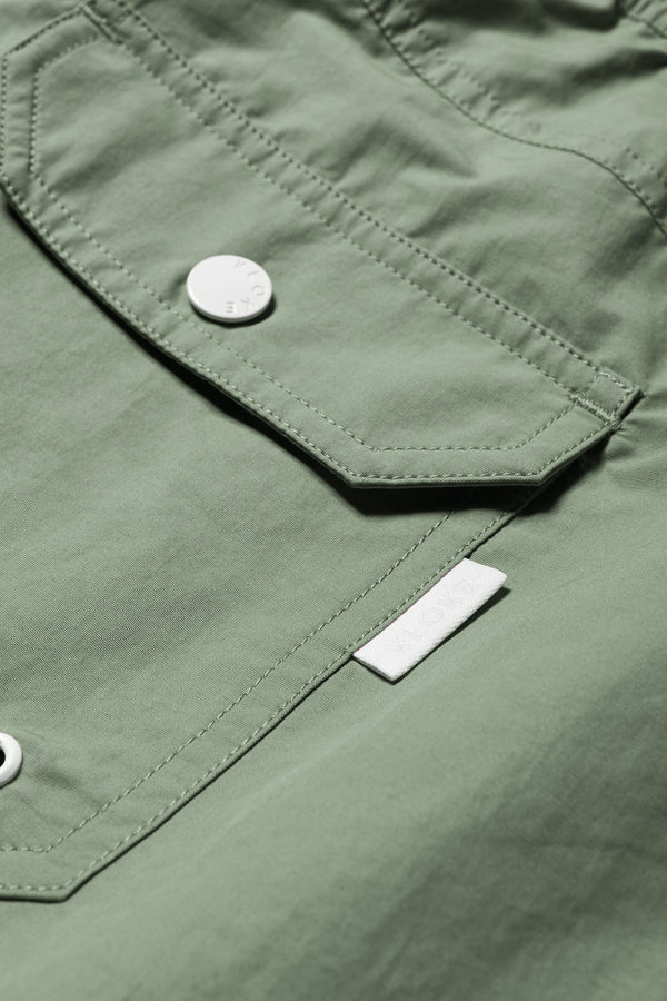Close up details of The New Wave Short in Fatigue Green. Swim shorts with elastic drawstring waist, internal mesh support, and front slant pockets. Available in 5 sizes.