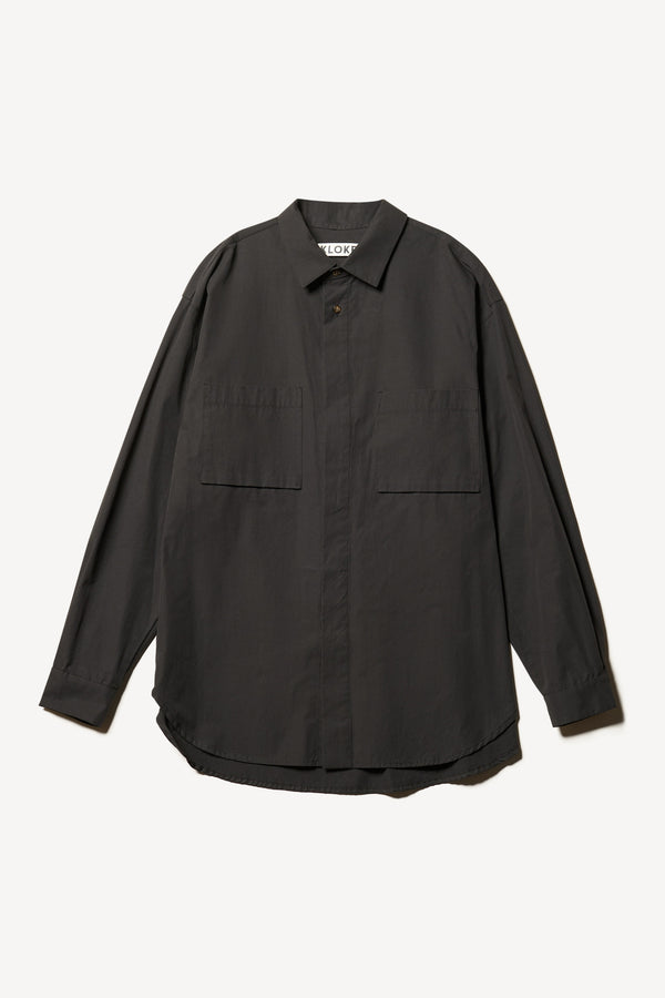 Flat front of the Offset Shirt in a black heavyweight cotton, featuring a relaxed fit and utility chest pockets.