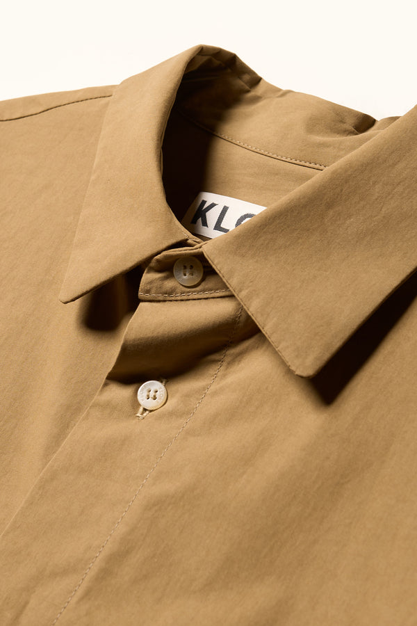 Close up Collar details shot of the Offset Shirt in a dusty olive heavyweight cotton, featuring a relaxed fit and utility chest pockets.
