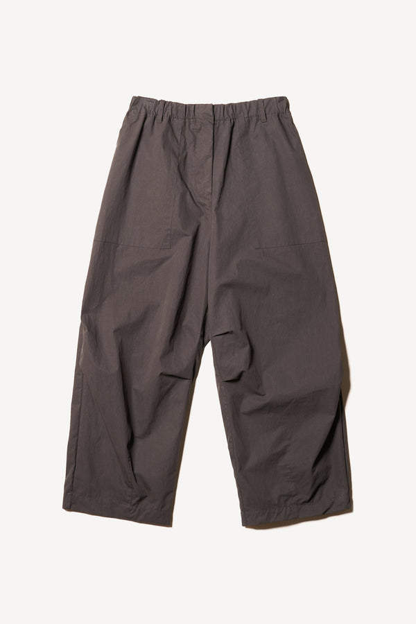 Flat front of the Output Pant in black, a relaxed fit with wide tapered leg and clean patch pockets 