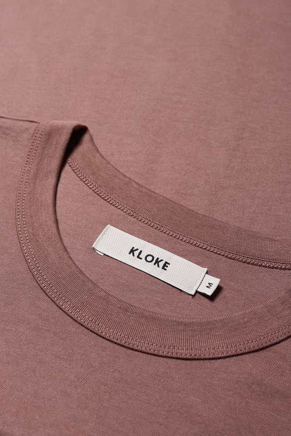 Close up neckline of The Pfutze Print T Shirt in Cocoa Brown. A classic t-shirt cut from a soft cotton jersey, with a thick rib neckline and straight hem. Available in 5 sizes. 