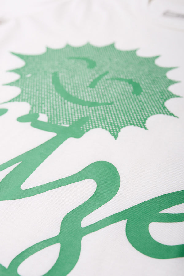 Close up detail of The Pfutze Print T Shirt in White and Green. A classic t-shirt cut from a soft cotton jersey, with a thick rib neckline and straight hem. Available in 5 sizes. 