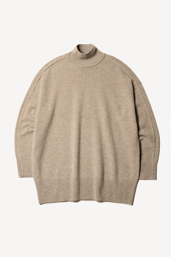 Flat front of the Prism mock neck merino wool fisherman sweater with exposed seams in Taupe. 