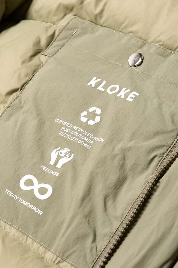 Close up inside pocket detail shot of the  Men’s Prospect Down Puffa a technical jacket with removable hood and utility pockets, made from recycled nylon. In Dusty Olive Green 