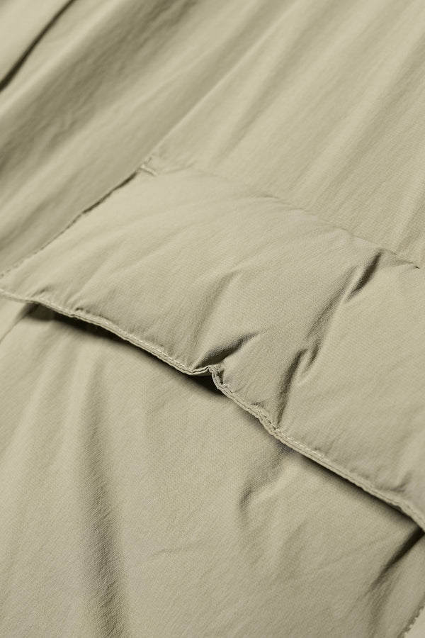 Close up pocket detail shot of the  Men’s Prospect Down Puffa a technical jacket with removable hood and utility pockets, made from recycled nylon. In Dusty Olive Green 