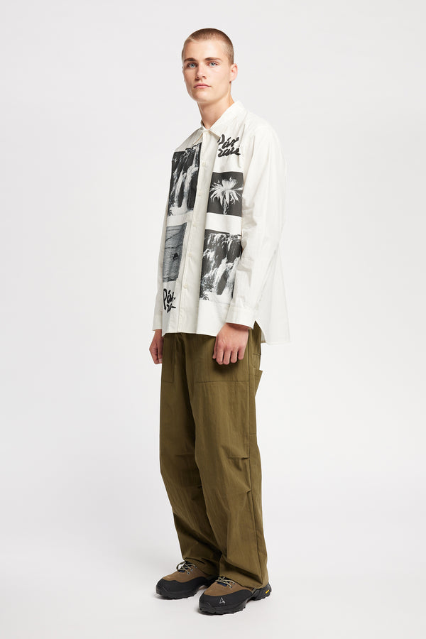Front of Model wearing the Rame shirt, an off-white printed shirt with relaxed fit, structured collar, and vintage-photo placement print.
