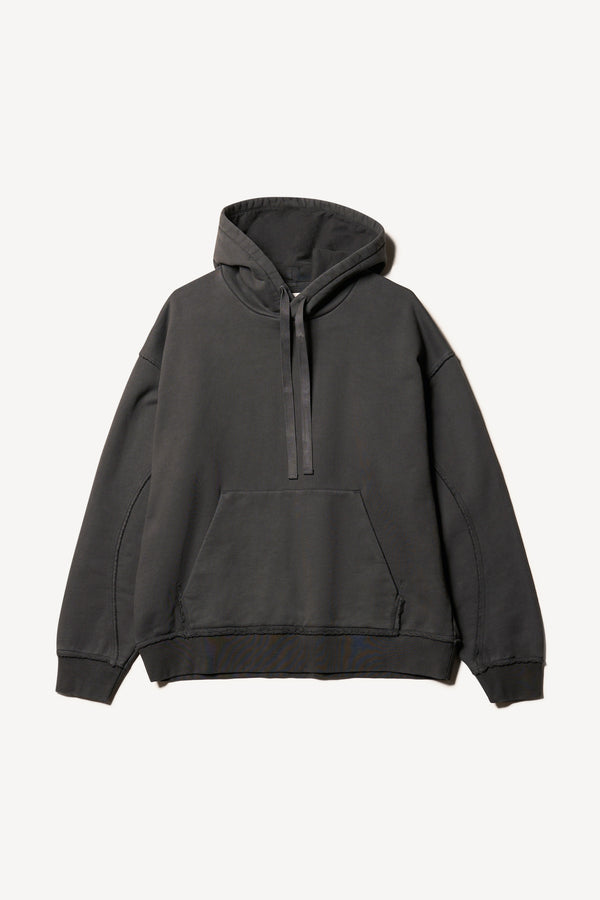 Flat front of oversized pigment-dyed hoodie with dropped shoulders and kangaroo pocket in jet black