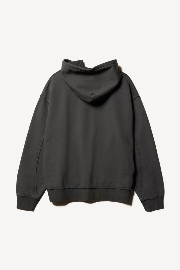 Flat back of oversized pigment-dyed hoodie with dropped shoulders and kangaroo pocket in jet black