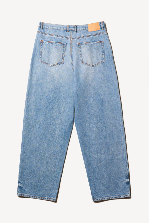 Flat back of the renew jean, a relaxed loose-fit straight style in premium Japanese denim, shown in mid-blue fade with five-pocket design and custom branded hardware.