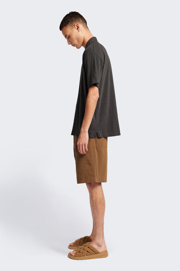 Side of The Tectonic Shirt in vintage black, a classic boxy fit T-Shirt made from 100% cotton garment dyed jersey with a reinforced back yoke. Available in 5 sizes. 