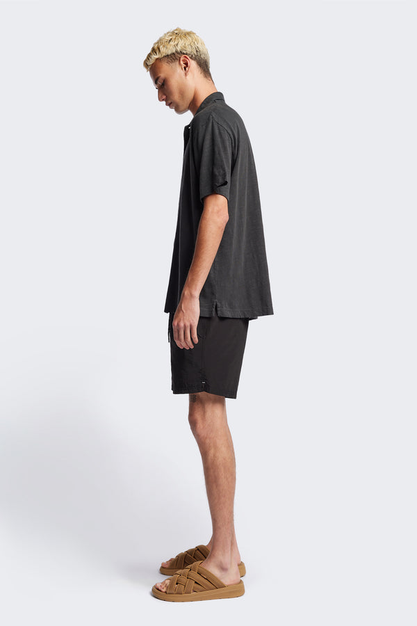 Side of The Tectonic Shirt in Vintage Black, a classic boxy fit T-Shirt made from 100% cotton garment dyed jersey with a reinforced back yoke. Available in 5 sizes. 