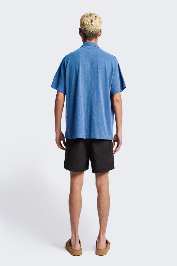 Back of The Tectonic Shirt in blue, a classic boxy fit T-Shirt made from 100% cotton garment dyed jersey with a reinforced back yoke. Available in 5 sizes. 