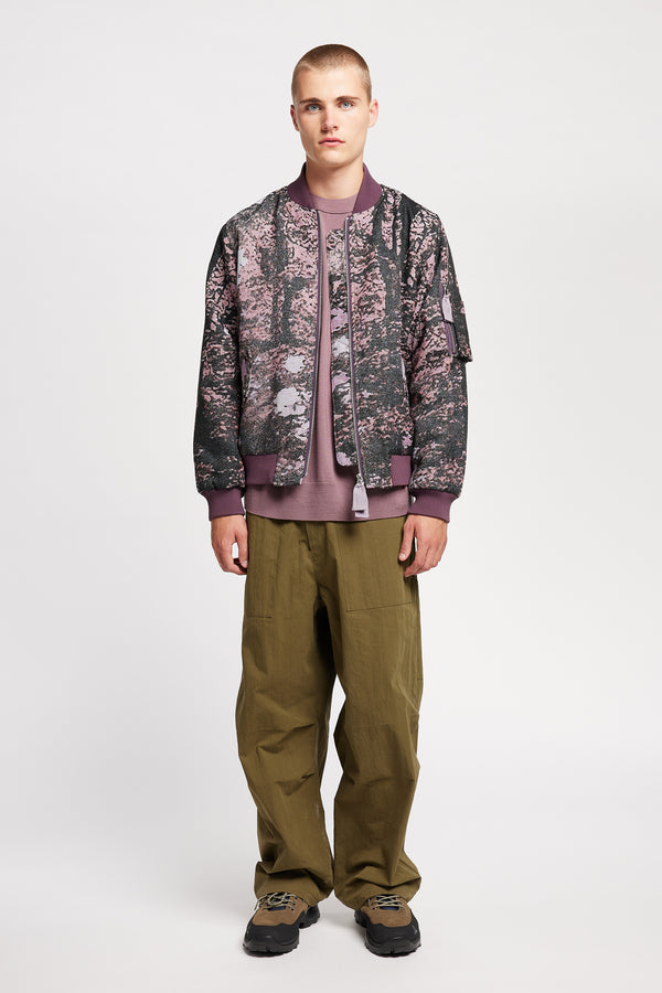 Men - Front of Unisex bomber jacket in Purple Print woven jacquard with real tree camouflage, featuring dropped shoulders, ribbed trims, and full-length front zip.