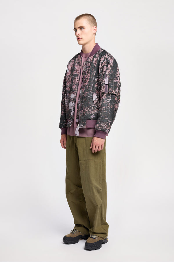Men - Front of Unisex bomber jacket in Purple Print woven jacquard with real tree camouflage, featuring dropped shoulders, ribbed trims, and full-length front zip.