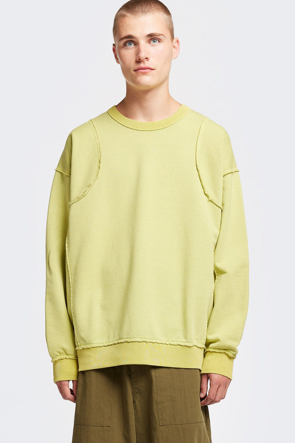 men - model wearing Unisex format oversized crew neck sweater in chartreuse  with clean panelled design and raw flat-locked seams, displayed from the front.