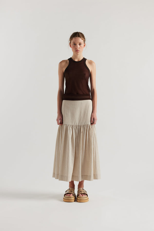 Front of Model in the Ecru and Black Pin Stripe Panelled cotton skirt with gathered full silhouette, wide yoke waist, and invisible back zip closure.